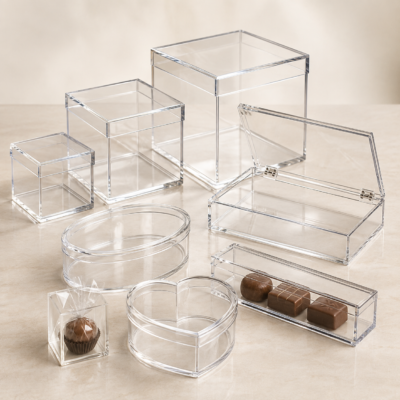 Clear acrylic plexi boxes in square, rectangular, oval, and heart shapes for gifts and chocolates.